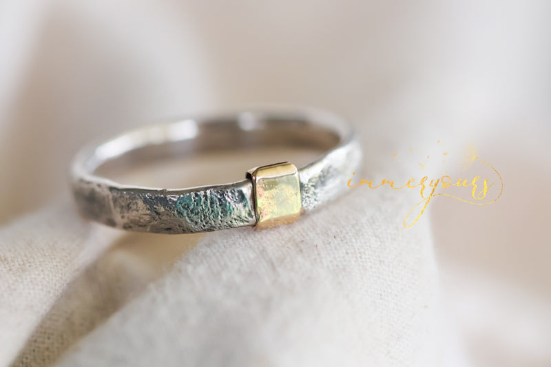 Masculine memorial Silver ring with a gold accent on a soft beige background