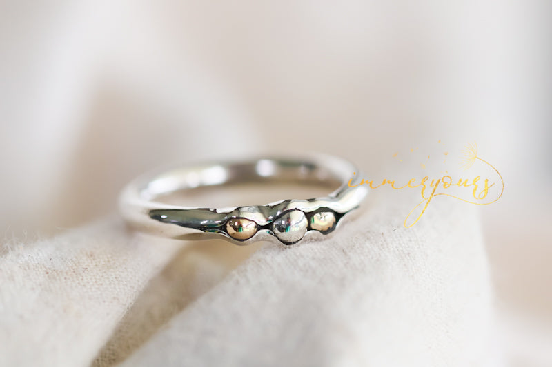 Memorial ring with small stones on a soft white background